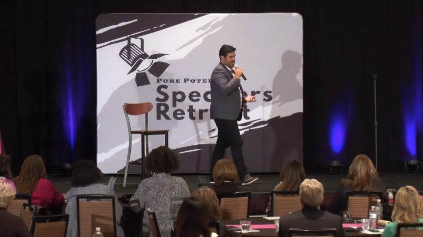 Steve Lemus speaking on stage at the Pure Potential Speakers Retreat